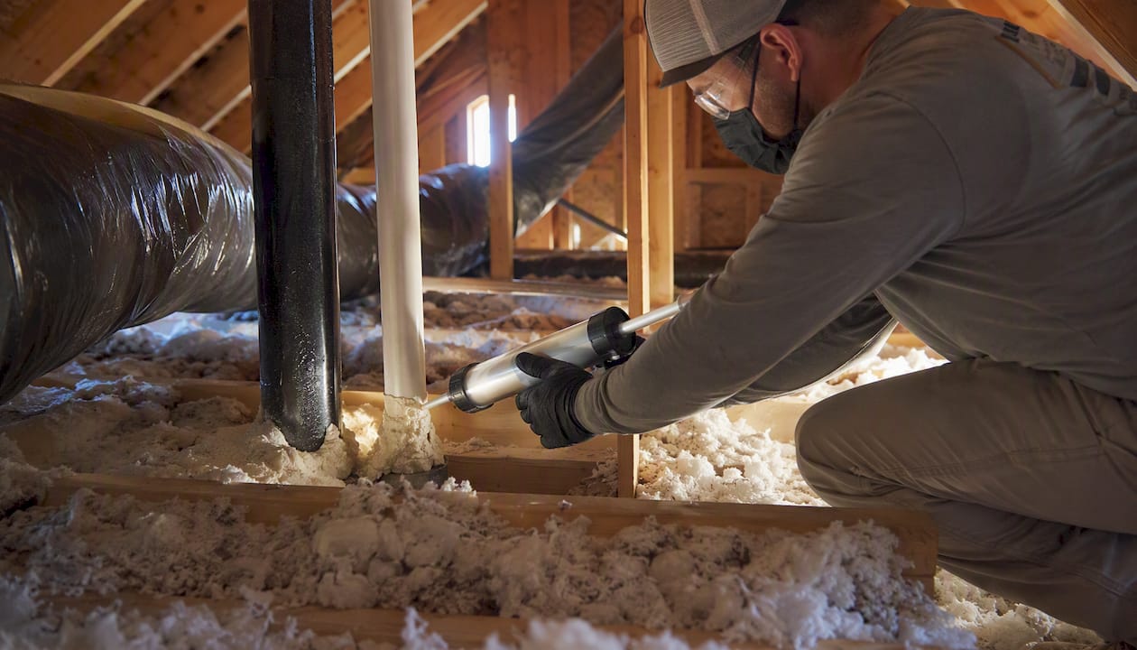 Contractor air sealing attic penetrations