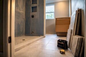 Bathroom under renovation with construction materials and tools present.