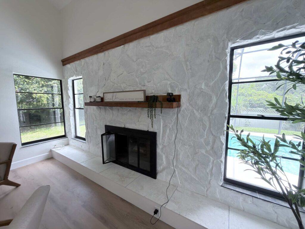 Fireplace remodel Tampa Bay: natural stone surround with a floating timber shelf