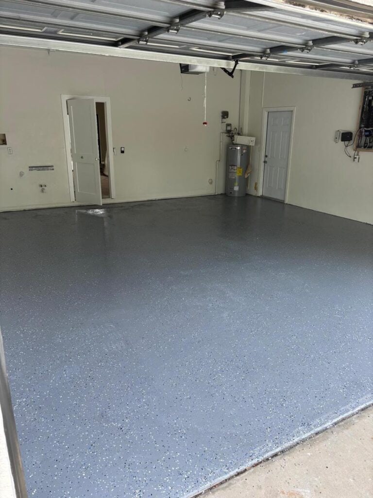 Flooring contractor Tampa Bay: grey epoxy flake garage floor over a prepared slab