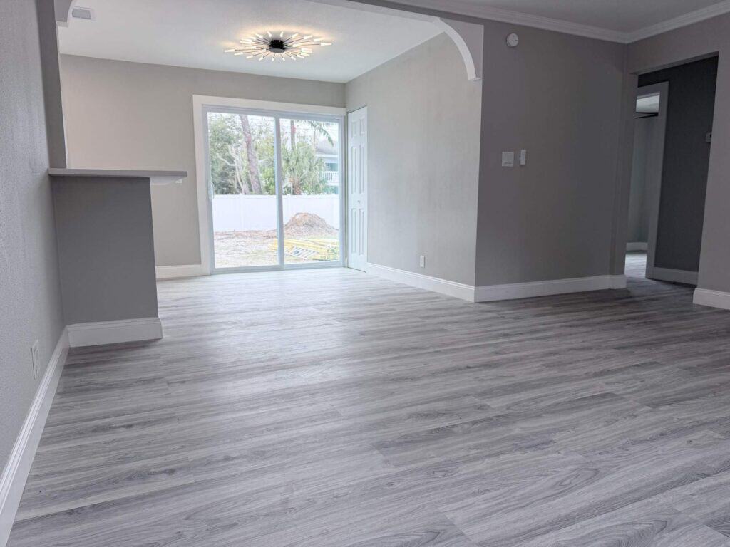 Flooring contractor Tampa Bay: one plank floor running through an open plan living area