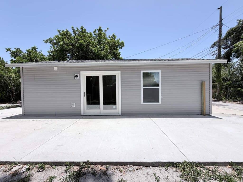 Garage conversion contractor Tampa Bay: French doors and a window where the garage door used to be