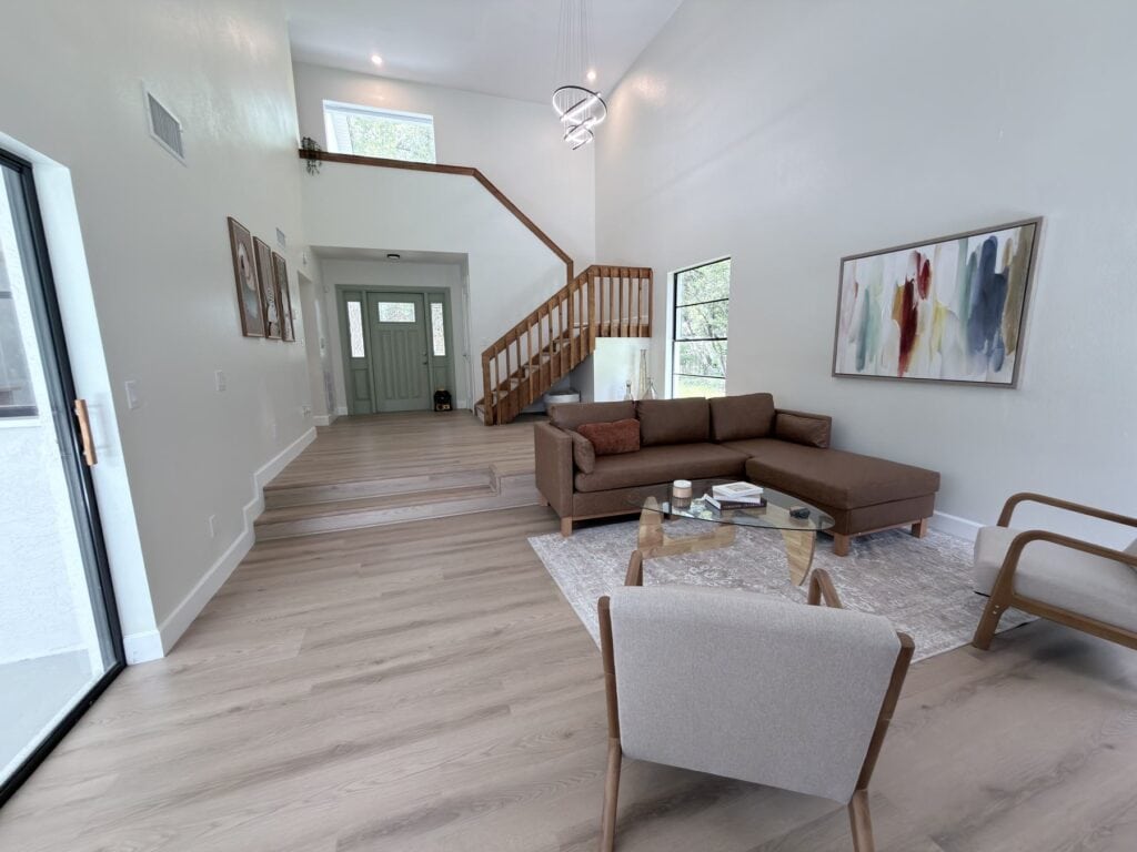 LVP flooring Tampa: wood-look plank floor running through a staged living room