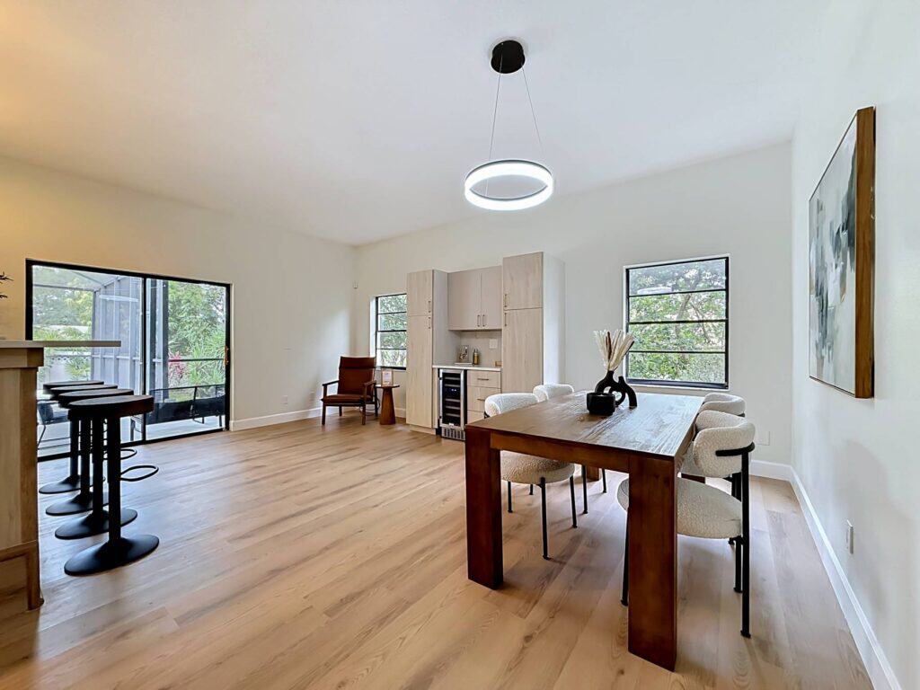 LVP flooring Tampa: one plank floor carried from the dining area through to the living room